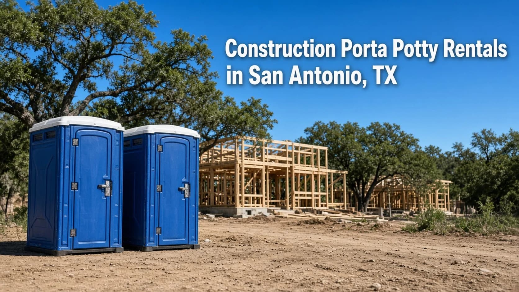 Two blue portable toilets on clean graded dirt at a residential construction site with house framing and live oaks behind them, with the headline Construction Porta Potty Rentals in San Antonio, TX