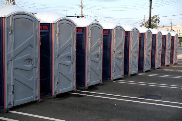 Row of portable restrooms set up at an outdoor festival
